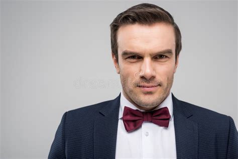 Portrait Of Handsome Man In Suit And Bow Tie Looking At Camera Stock
