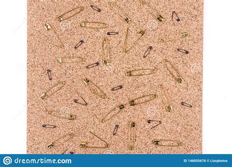 Gold Safety Pins Spread Out On A Piece Of Cork Stock Photo Image Of