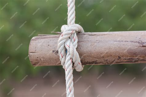 Premium Photo A Rope Is Tied In A Knot Around A Fence Post Rope Tied