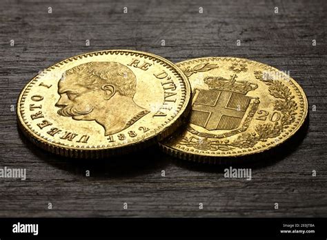Italian 20 Lira Gold Coins On Rustic Wooden Background Stock Photo Alamy