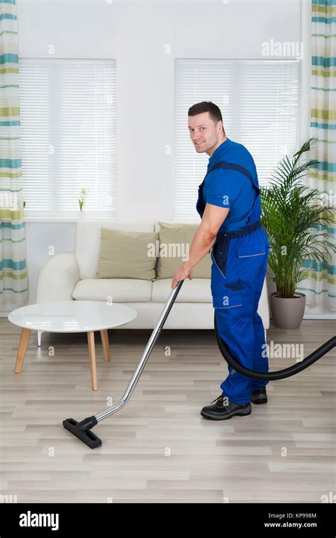 Worker Cleaning Floor With Vacuum Cleaner Stock Photo Alamy