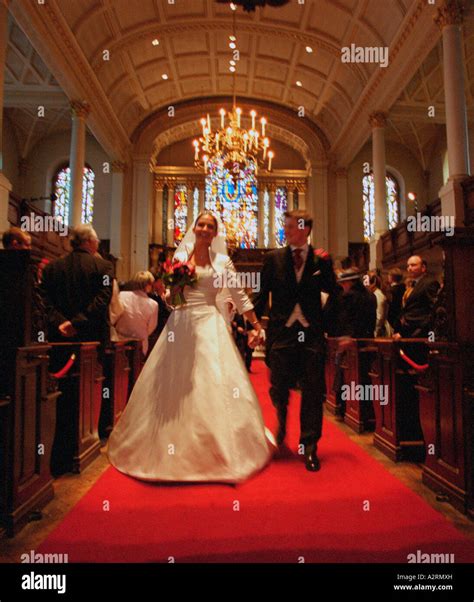 Bride With Her Groom Walk Down The Aisle Of St Georges Church London