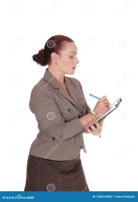 Business Woman Holding Her Clipboard And Pen And Writing Stock Image