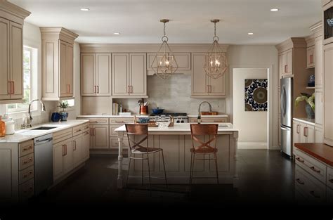Modern white glossy kitchen cabinets and counter top. Bertch Cabinets