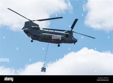 Double Rotor Heavy Airlift Military Helicopter In Flight Carrying