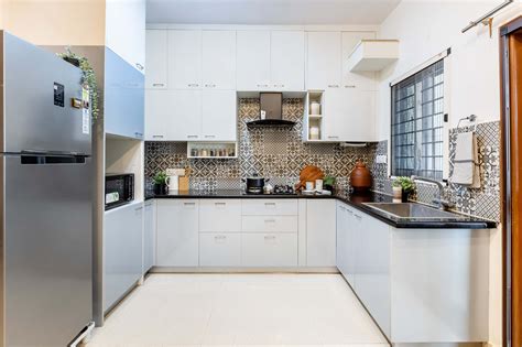 Spacious Modular Kitchen Design With Light Blue And White Storage Units