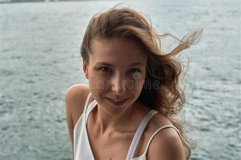Beautiful Young Girl With Brown Hair And Awesome Eyes On The Ocean