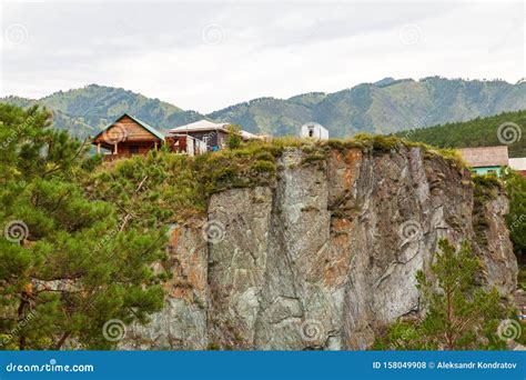 A Country House On The Edge Of A Cliff Near A Mountain In A Rocky Area