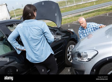 Two Drivers Arguing After Traffic Accident Stock Photo Alamy