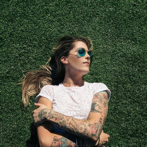 Blonde Tattooed Woman Lying On The Grass Stock Image Everypixel