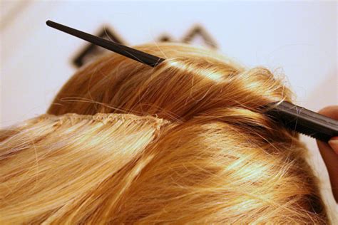 Section off the hair around the crown of your head in a circular shape using a rattail comb. DIY Halo Hair Extensions