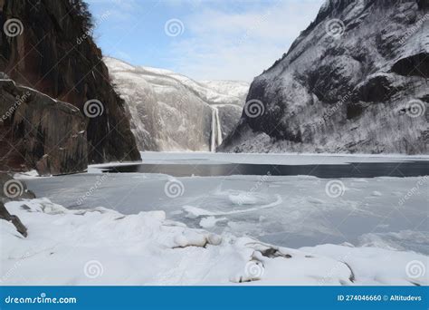 Freezing Fiord With View Of Rocky Cliff Face And Waterfalls Stock