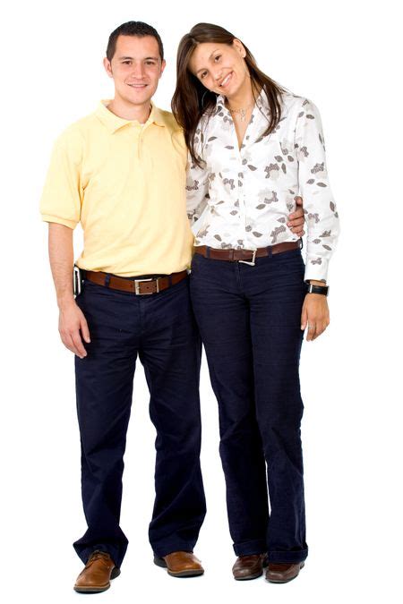Young Couple Smiling And Standing Next To Each Other Isolated Over A