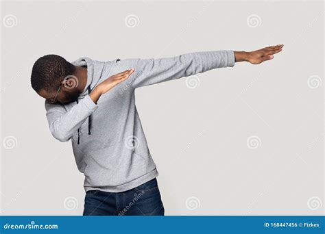 African Guy Performing Dabbing Dance Isolated On Grey Studio Background Stock Photo Image Of