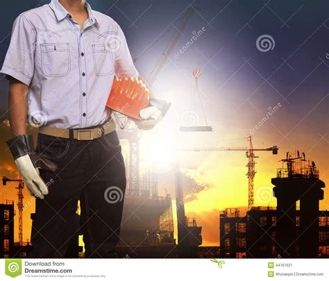 Engineer Man Working With White Safety Helmet Against Crane And