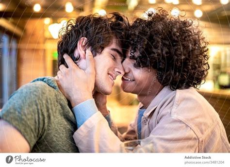 Multiethnic Gay Couple Flirting During Date In Cafe A Royalty Free