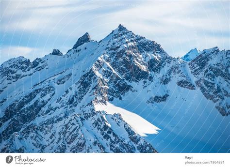 Snowy Blue Mountain Peaks In Clouds A Royalty Free Stock Photo From