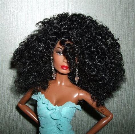 A Doll With Long Black Hair Wearing A Blue Dress