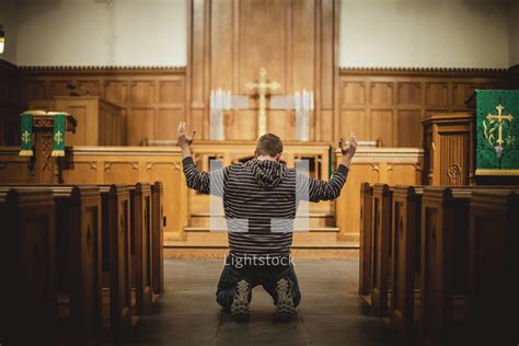 Stock Photo Man Praying Inside Church By Shaun Menary Lightstock