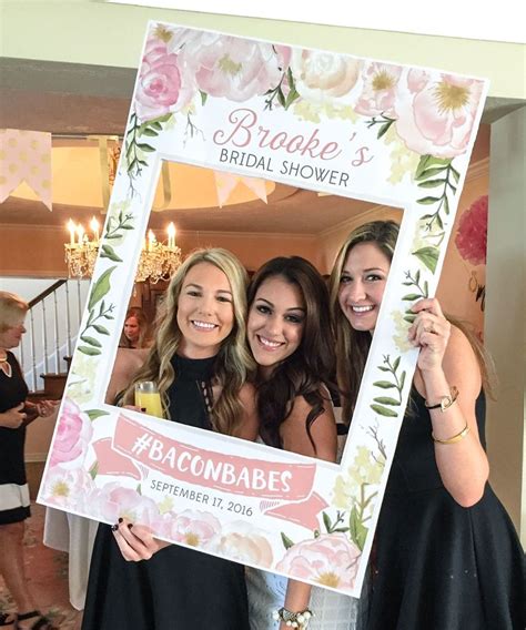 bridal shower photo booth idea photo frame for bridal shower with floral motif hashtag