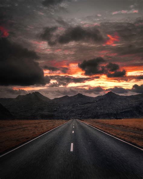 Empty Highway Overlooking Mountain Under Dark Sky In 2021 Landscape