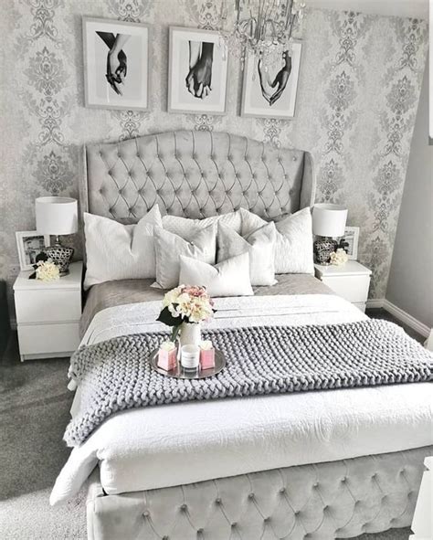 A Bedroom With A Bed Nightstands And Flowers On The Headboard In Black