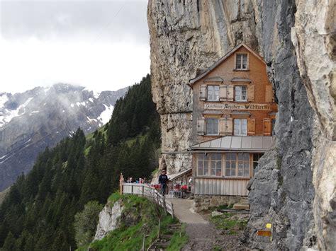 High In The Swiss Alps Is A Tiny Mountain Hut Perched Just Under The