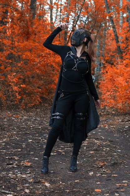 Premium Photo A Girl In A Bdsm Costume And A Black Mask In A Red