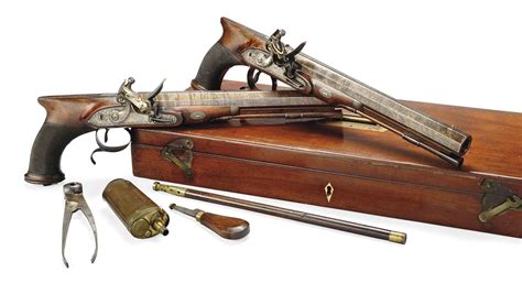 A CASED PAIR OF 16 BORE FLINTLOCK SAW HANDLED DUELLING PISTOLS BY T