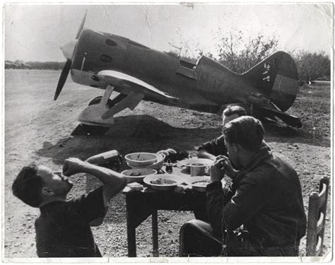 Loyalist Pilots Eating Drinking And Resting Near Their Airplane