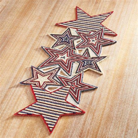 Five Red White And Blue Stars Sitting On Top Of A Wooden Table Next To