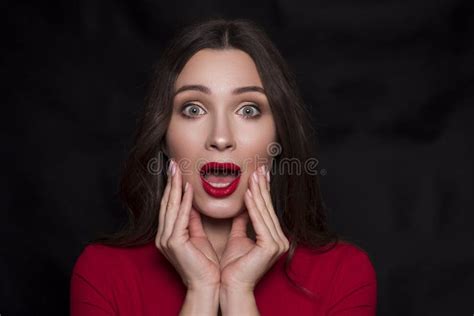 Emotional Head Shot Portrait Of A Brunette Caucasian Woman In Red Dress And With Red Lips On