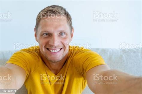 Friendly Guy With A Wide Whitetoothed Smile Takes A Selfie Portrait Of