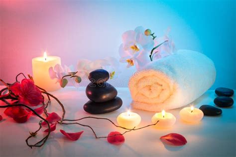 Massage Composition Spa With Candles Orchids And Black Stones In