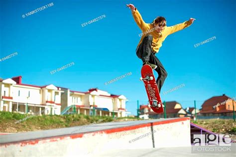 A Teenager Skateboarder Does An Ollie Trick In A Skatepark On The