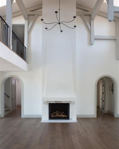 Stunning 2 Story Living Room Features A Two Story Fireplace Boasting A