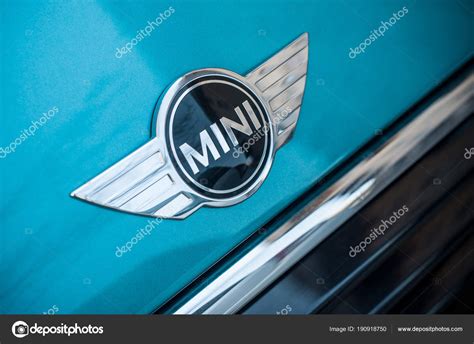 Retail Of Austin Mini Cooper Logo On Blue Car Parked In