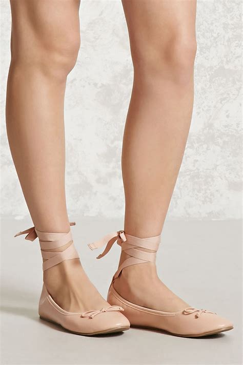A Pair Of Faux Leather Ballet Flats Complete With Lace Up Self Tie