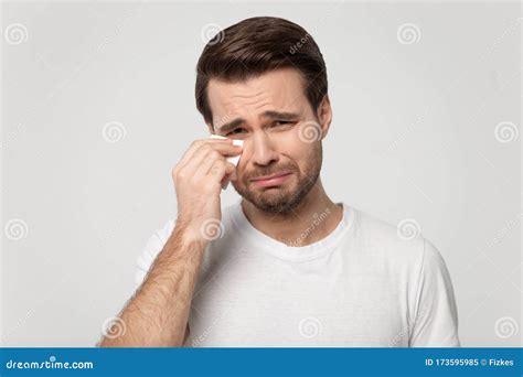 Upset Offended Millennial Guy Holding Paper Tissue Wiping Tears Stock