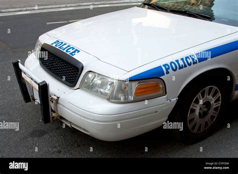 Front And Side View Of A White Police Car With Blue Letters Saying