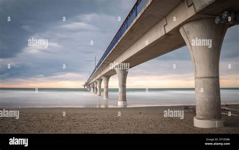 Massive Concrete Pier Leading To Horizon Surrounded By Ocean Long