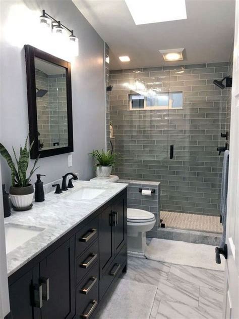 A Bathroom With Two Sinks A Toilet And A Walk In Shower