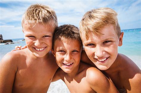 Three Happy Boys On The Beach Stock Photo Download Image Now 8 9