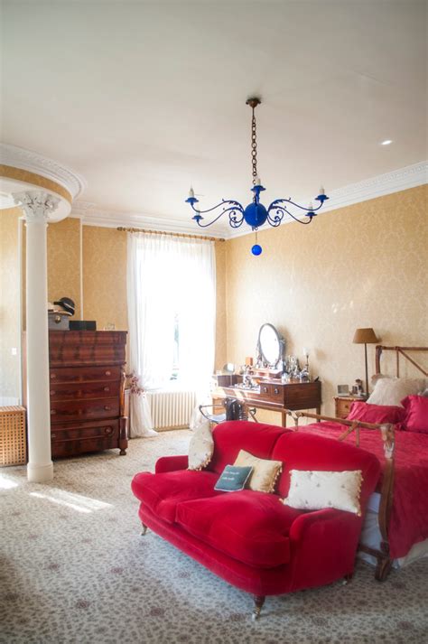 A traditional brass chandelier adds a luxurious touch to the master bedroom, especially when paired with wall sconces for highly versatile layered lighting. Chic blue chandelier Traditional Bedroom