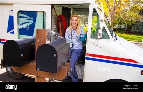 Female United States Postal Service carrier delivering mail in