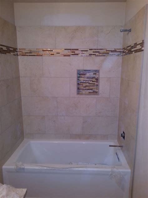 Using inexpensive square tiles in a couple colors and finishes, your allover bathroom tile design is going to get a lot more interesting. ATX Tile built tub surround 12x24 inch tile stacked on ...