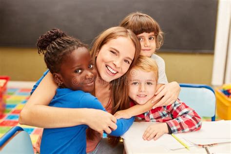 Teacher Hugs Children In The Day Care Center Stock Photo Image Of