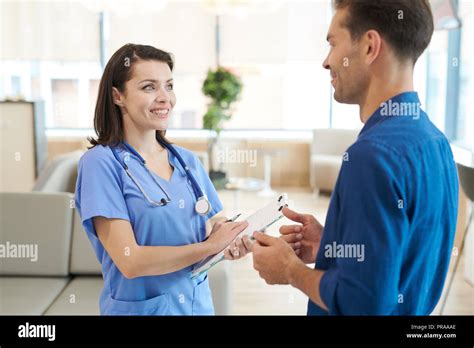 Smiling Nurse Talking To Patient Stock Photo Alamy