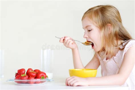 Adorable Little Girl Eating Cereal In A Kitchen Stock Image Image Of