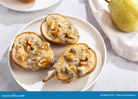 Baked Pears With Blue Cheese Walnuts And Honey On White Plate And